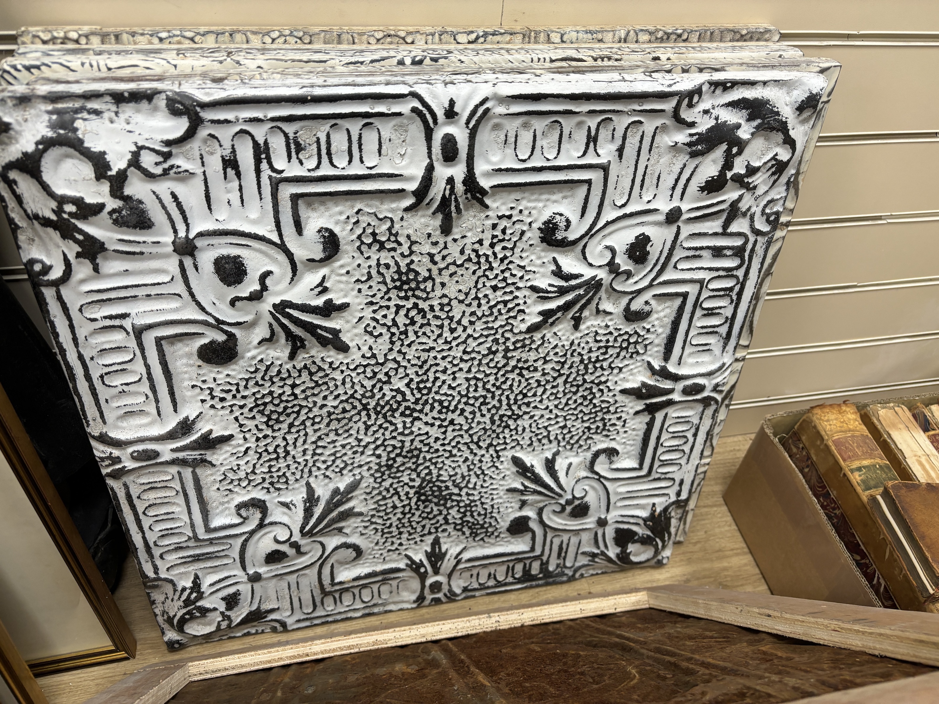 A group of nine decorative pressed tin panels made from salvaged antique tin ceilings, 59cm sq.